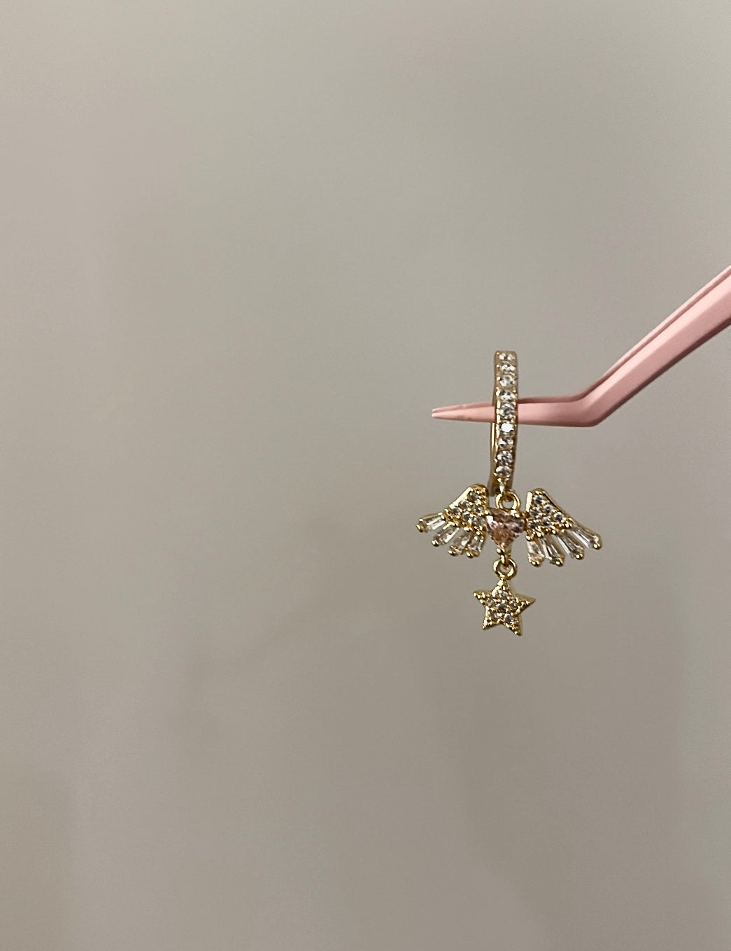 Gold star winged belly ring