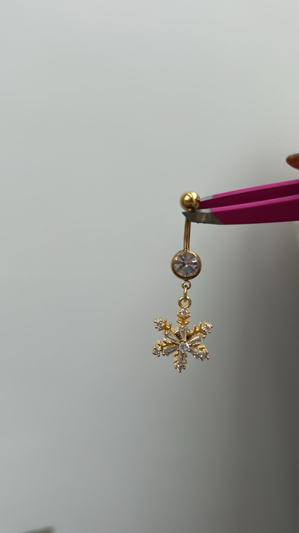 Gold snow flake pendant belly bar